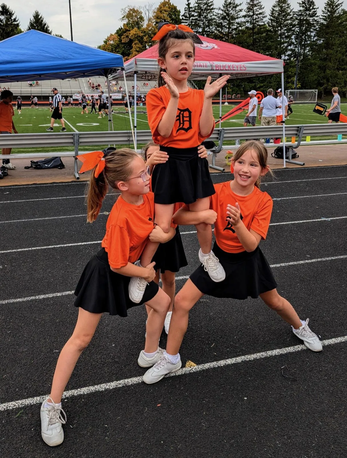 Jr Pacers cheerleader lifted in a stunt