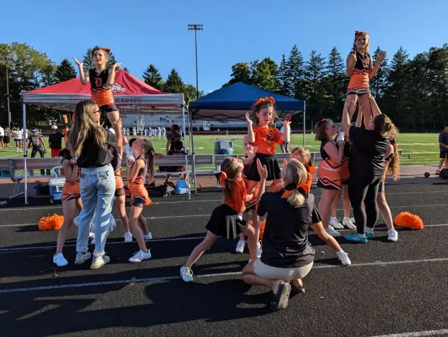 Jr Pacers cheerleaders stunting at a game