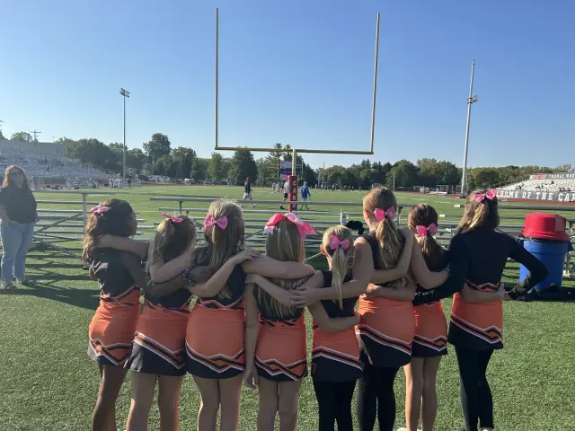 Jr Pacers cheer squad huddled together