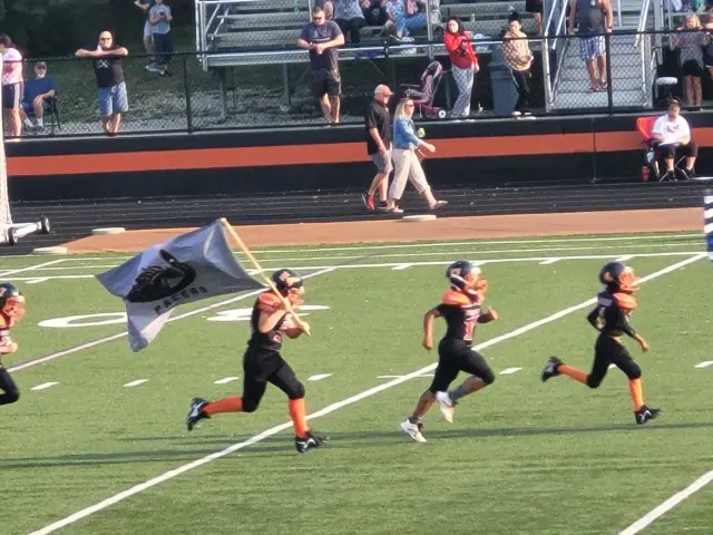 Jr Pacers player carrying the team flag