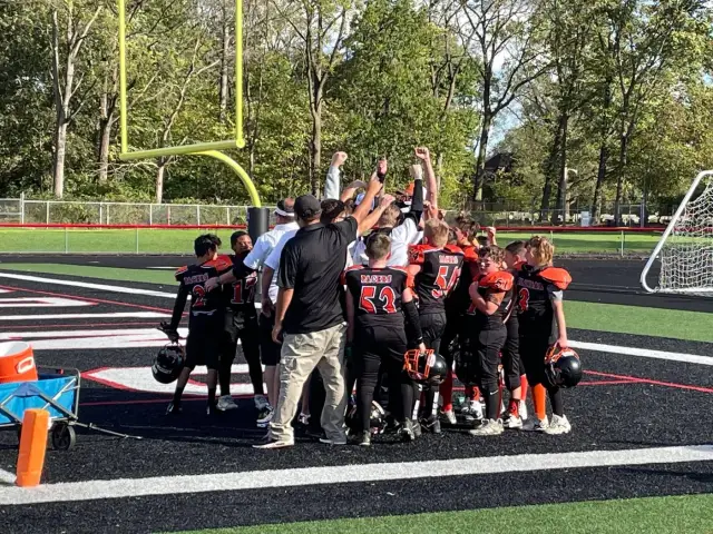 The Jr Pacers celebrating together in the end zone
