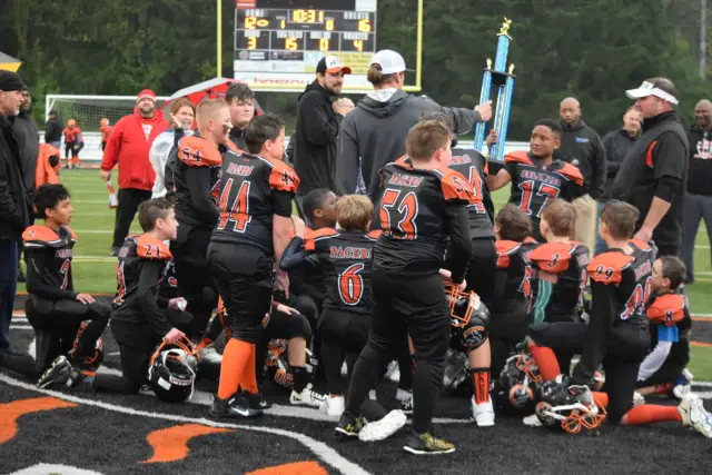 The Jr Pacers team taking a knee together