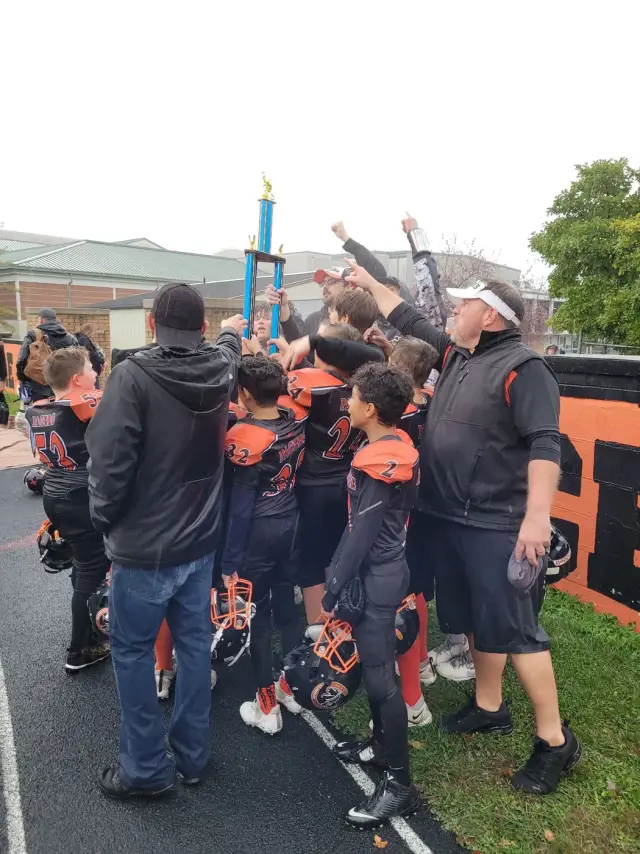 The Jr Pacers team huddled together in the rain