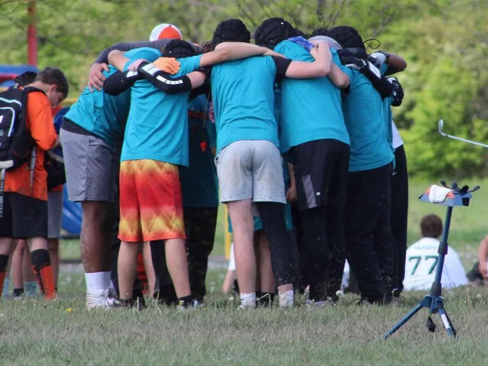 A Jr Pacers 7v7 team huddles up to get the play