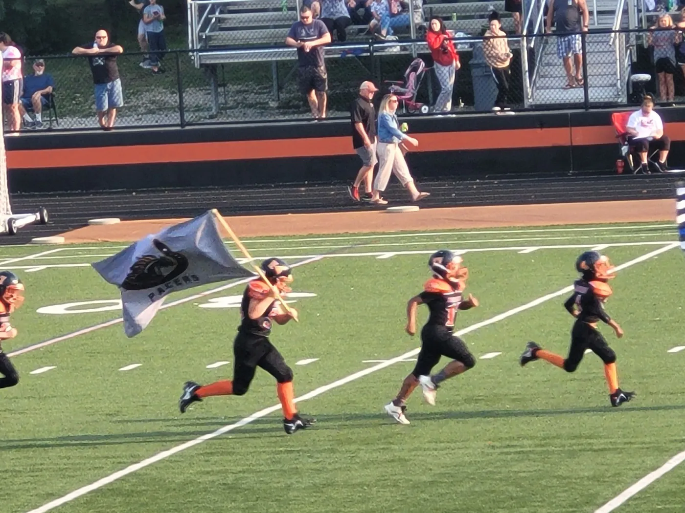 Jr Pacers player carrying the team flag
