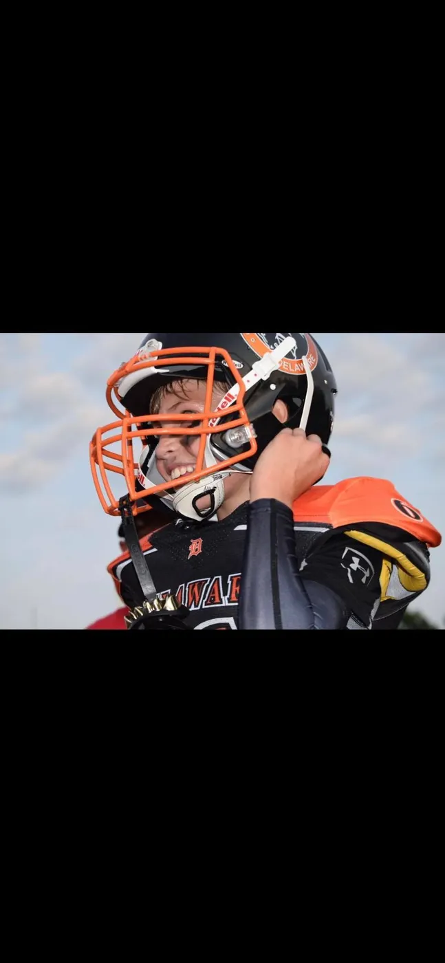 Jr Pacers player adjusting his helmet