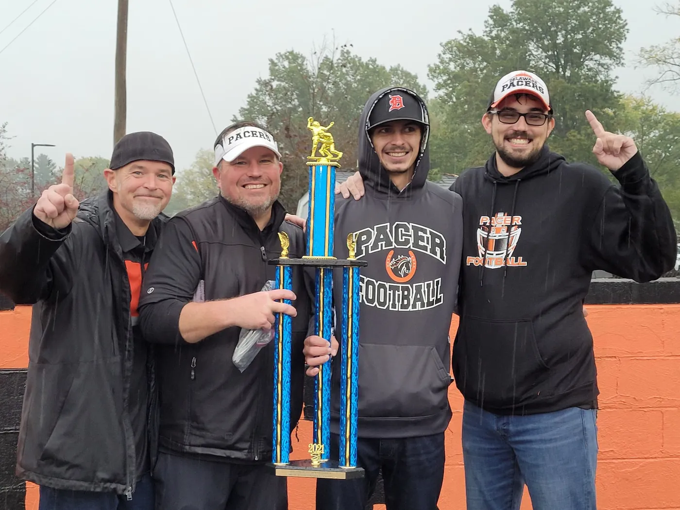 Jr Pacers coaches with the team trophy